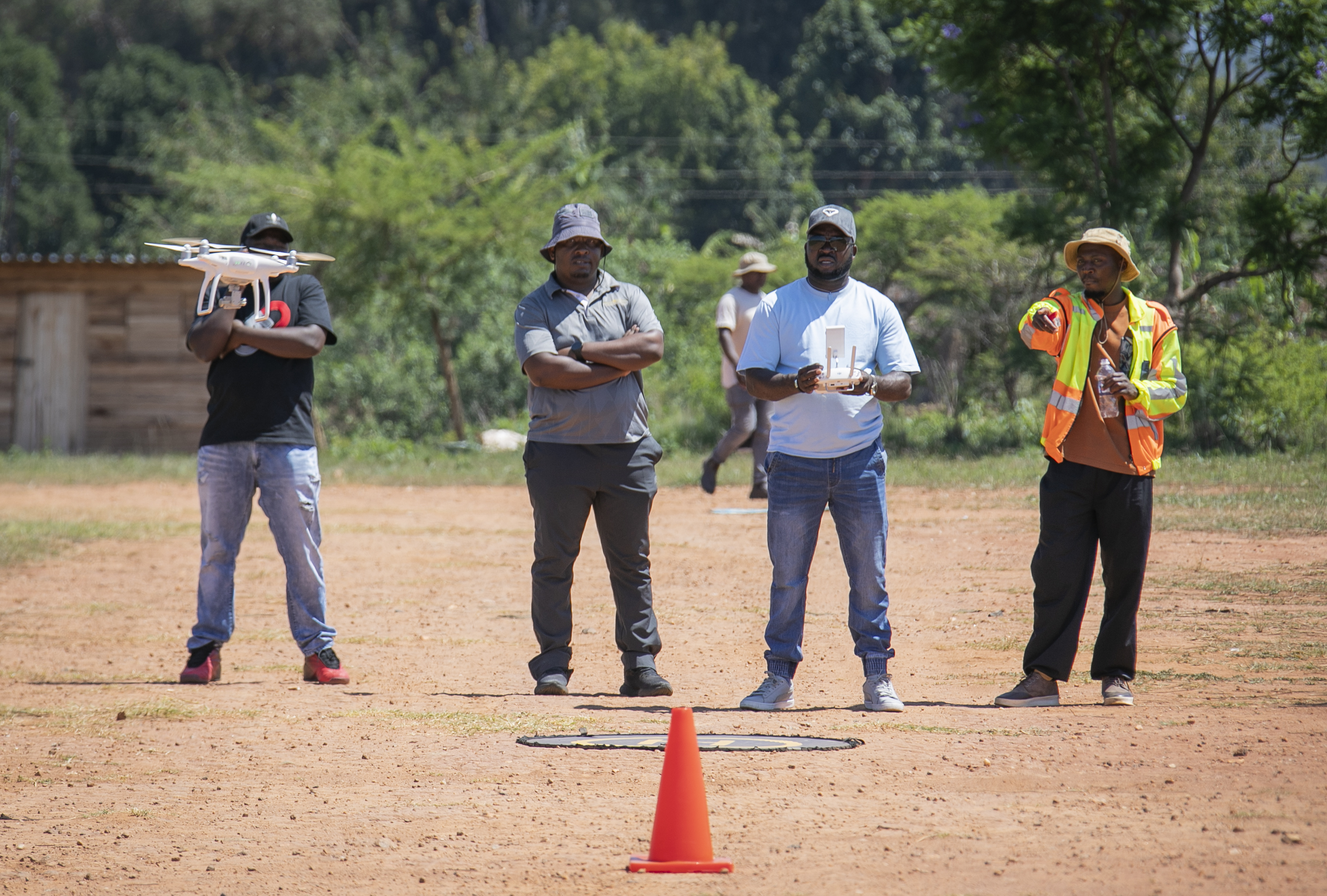 Drone Solutions Training Institute students and instructor at a practical flight field